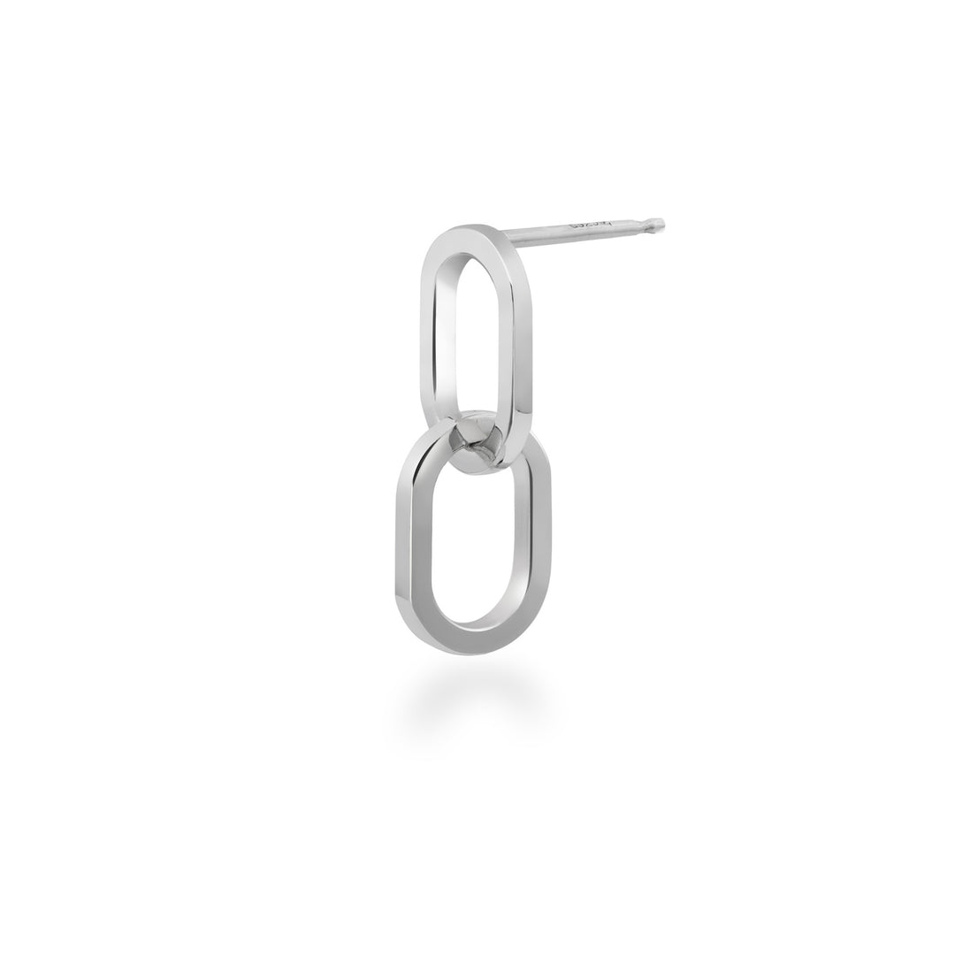 Silver interlocking hoop earring on a white background at an angle